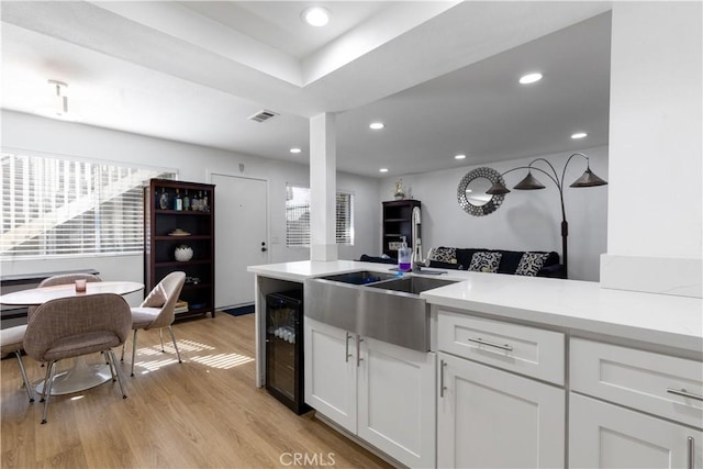 kitchen with light countertops, beverage cooler, and visible vents