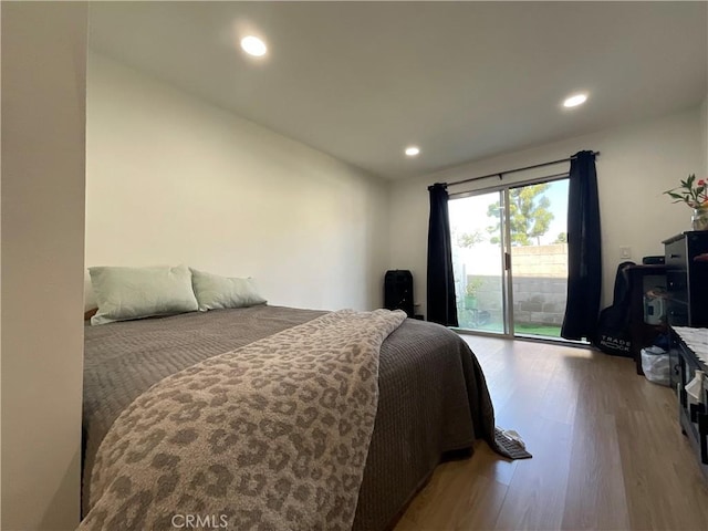 bedroom with access to outside, recessed lighting, and wood finished floors