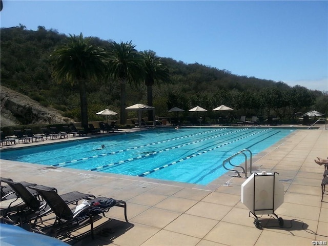 community pool with a patio area