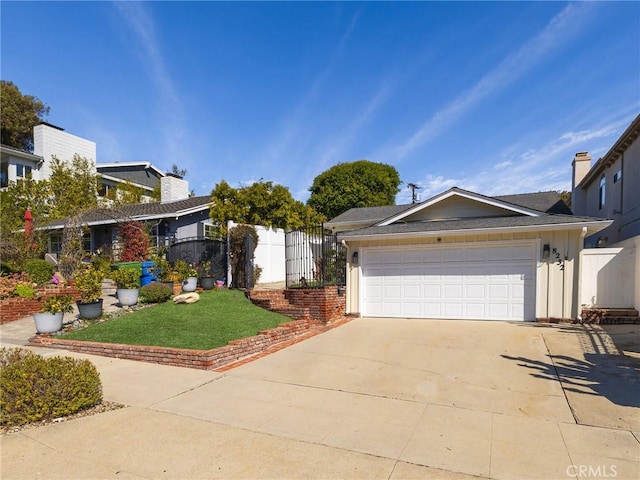 view of front of home with a garage, fence, concrete driveway, a gate, and a front yard