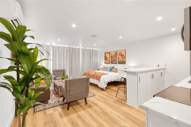 bedroom featuring light wood-type flooring and recessed lighting