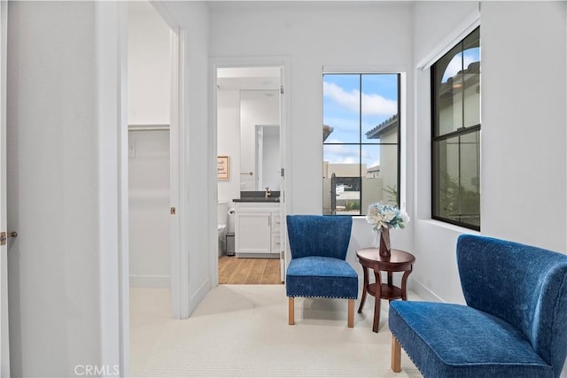 sitting room with light wood-type flooring and baseboards