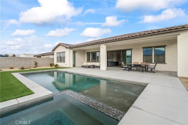 rear view of house with a patio area, fence, an outdoor living space, and stucco siding