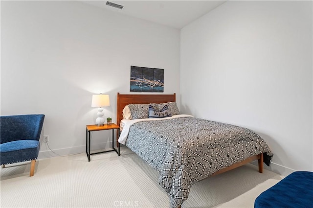 carpeted bedroom with visible vents and baseboards