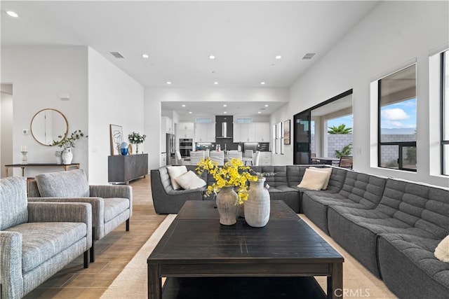 living area featuring recessed lighting, visible vents, and light wood-style flooring