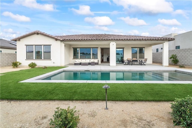 rear view of house featuring an outdoor hangout area, fence, a fenced in pool, stucco siding, and a patio area