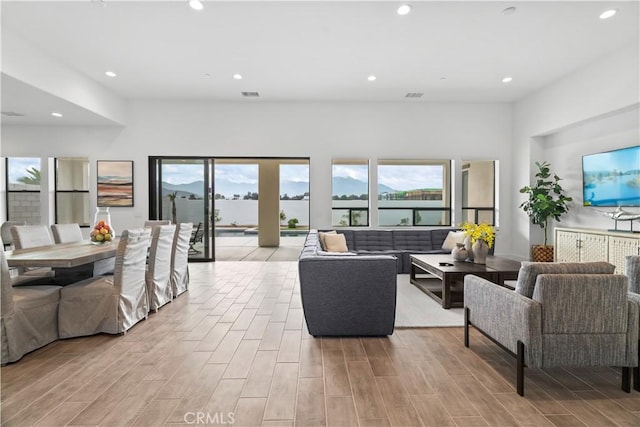 living area featuring recessed lighting and wood tiled floor