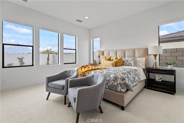 bedroom featuring light carpet, multiple windows, and visible vents