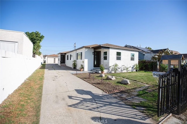 view of front of home with a garage, a front yard, fence, and stucco siding