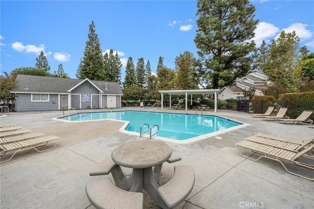 pool featuring a patio area and fence