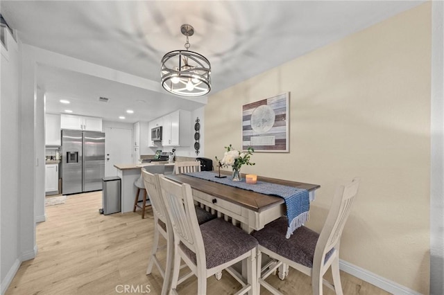 dining area with visible vents, baseboards, light wood-style flooring, a chandelier, and recessed lighting