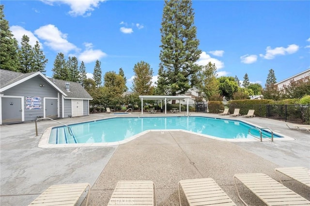 pool featuring a patio area and fence