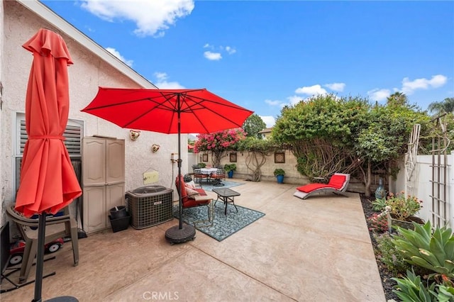 view of patio featuring outdoor dining area, a fenced backyard, and central AC unit