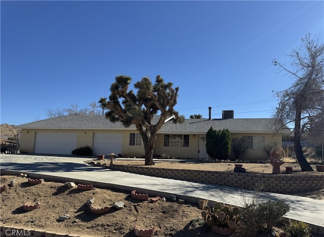 single story home featuring an attached garage and concrete driveway