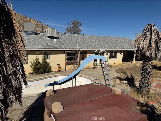 view of playground with a patio area and central AC