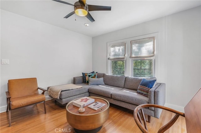 living room with ceiling fan, wood finished floors, and baseboards