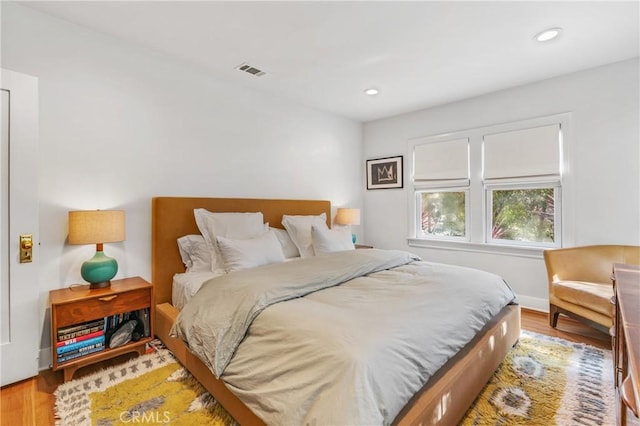 bedroom with wood finished floors, visible vents, and recessed lighting