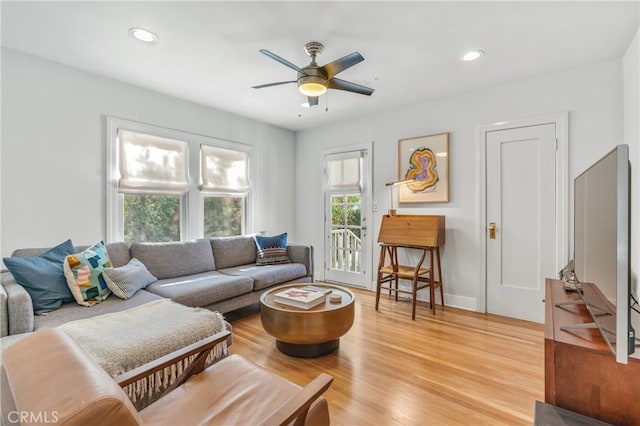 living room featuring recessed lighting, ceiling fan, light wood-style flooring, and baseboards