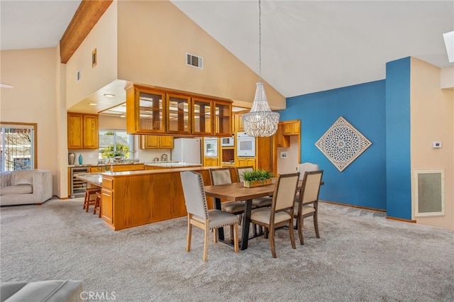 dining space featuring wine cooler, visible vents, and light carpet