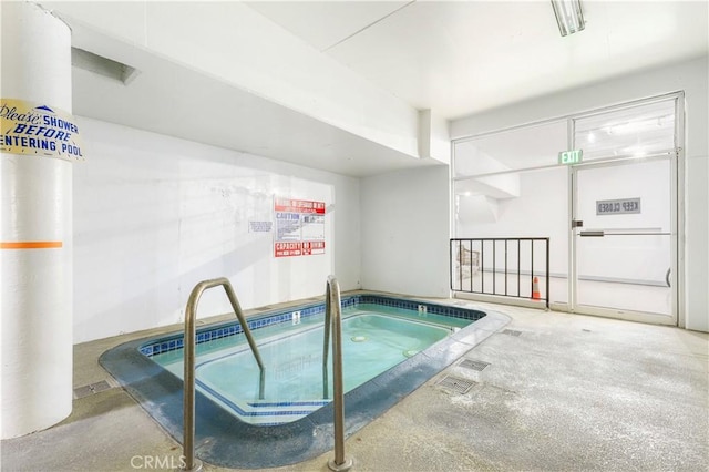 view of swimming pool with an indoor in ground hot tub