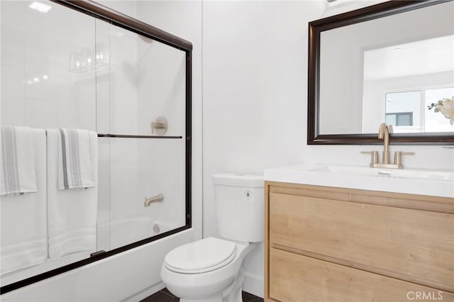 full bathroom featuring shower / bath combination with glass door, vanity, and toilet