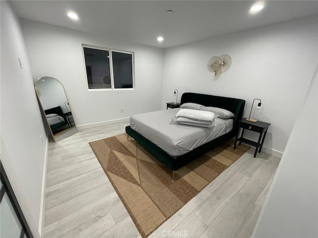 bedroom with recessed lighting, baseboards, and wood finished floors