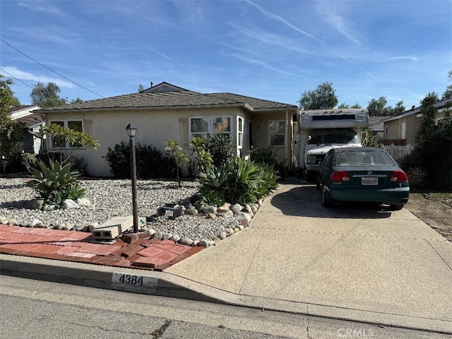 view of front of home with concrete driveway and stucco siding