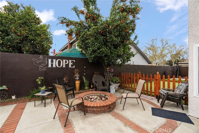 view of patio / terrace with an outdoor fire pit and fence