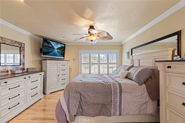 bedroom featuring crown molding, light wood-style flooring, ceiling fan, and a textured ceiling