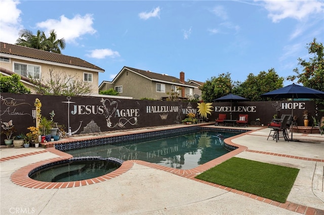 view of pool featuring a patio, fence, and a pool with connected hot tub