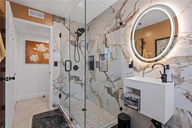 full bath with a sink, a marble finish shower, and visible vents