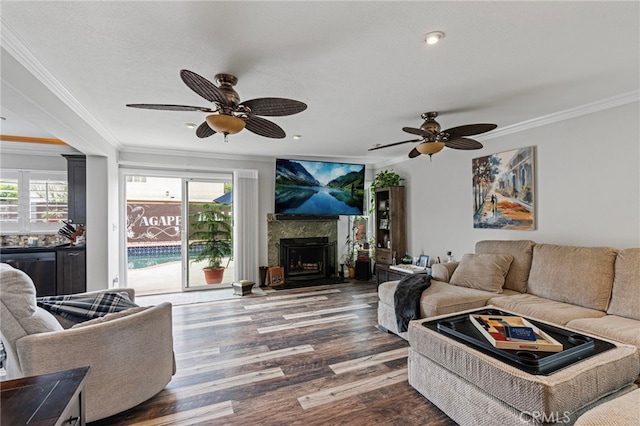 living room featuring a wealth of natural light, crown molding, wood finished floors, and ceiling fan
