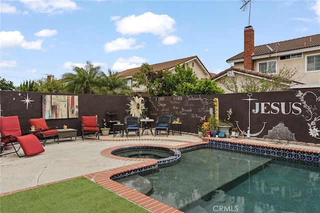 view of swimming pool featuring a fenced backyard, a pool with connected hot tub, and a patio