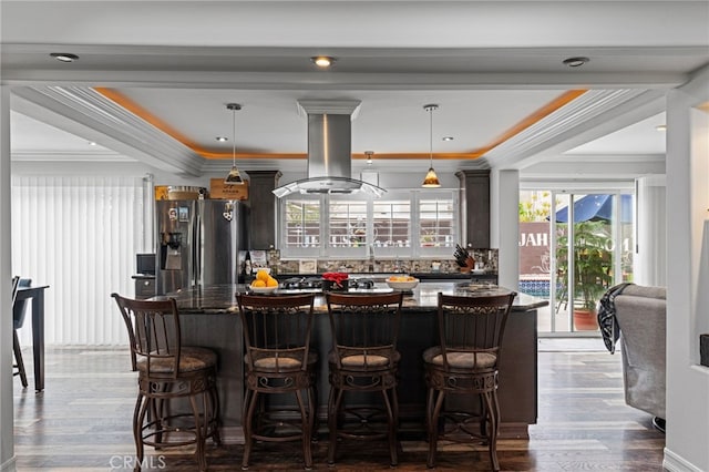 bar featuring decorative backsplash, wood finished floors, stainless steel refrigerator with ice dispenser, and island exhaust hood