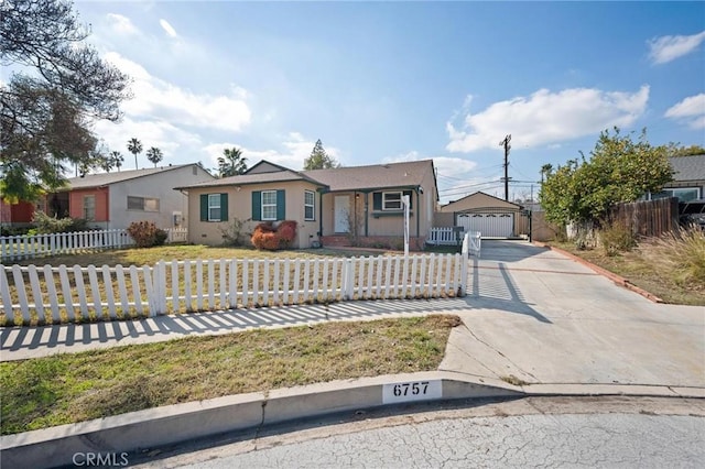 ranch-style home with a fenced front yard, a front yard, a garage, and stucco siding