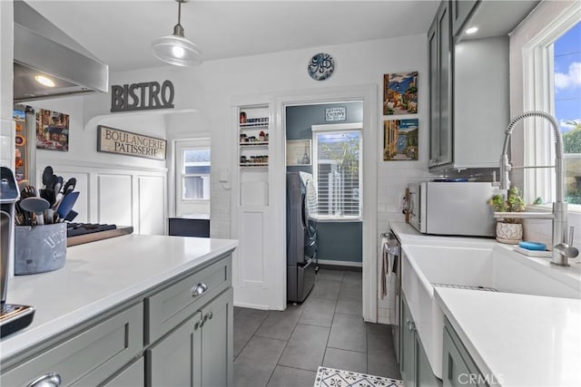 kitchen featuring light countertops and gray cabinetry