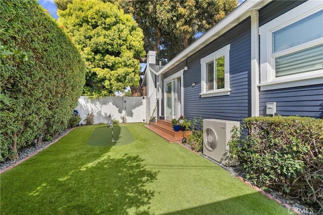 view of yard featuring ac unit and fence