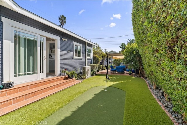 view of yard with entry steps, a patio, and ac unit