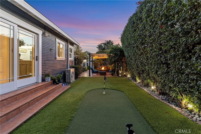 view of yard with entry steps, a patio area, and ac unit