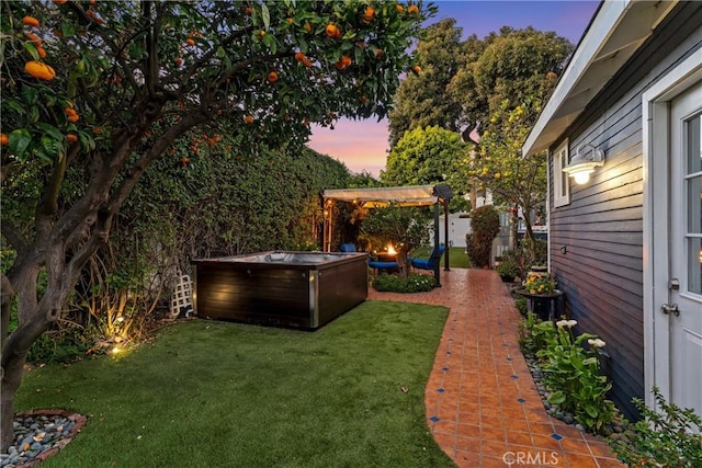 view of yard with a patio area and a hot tub