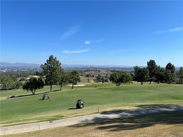 4018 Calle Sonora Este Unit C, Laguna Woods, CA 92637 - view of community with view of golf course, a mountain view, and a lawn