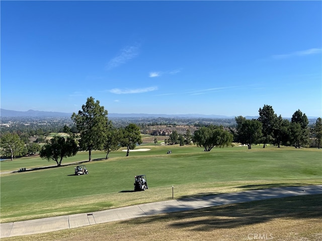 4018 Calle Sonora Este Unit C, Laguna Woods, CA 92637 - surrounding community with golf course view, a mountain view, and a lawn