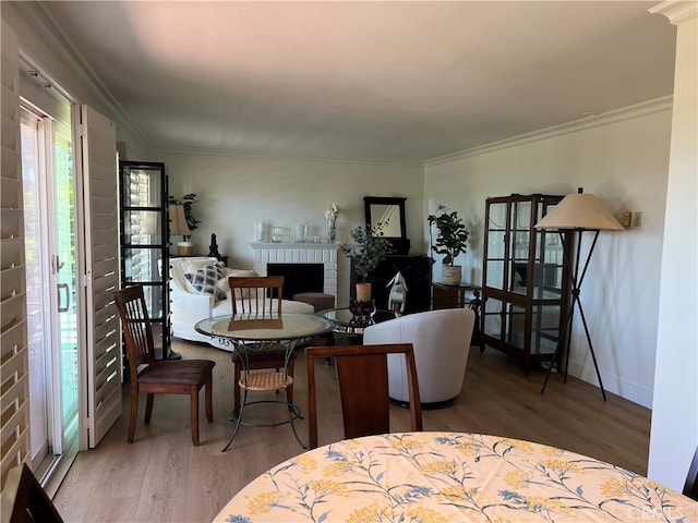4018 Calle Sonora Este Unit C, Laguna Woods, CA 92637 - dining space with wood finished floors, a brick fireplace, ornamental molding, and baseboards