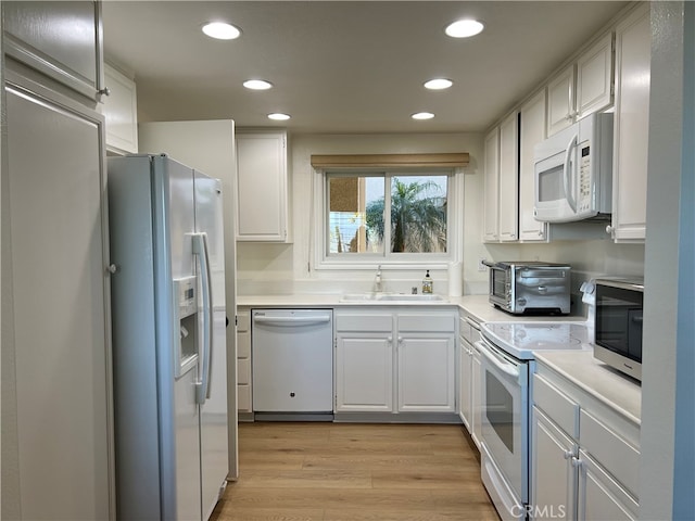 4018 Calle Sonora Este Unit C, Laguna Woods, CA 92637 - kitchen featuring white appliances, a sink, recessed lighting, light wood-style flooring, and light countertops
