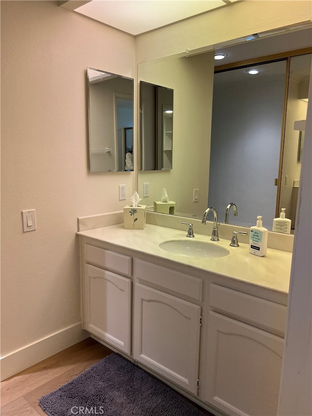 4018 Calle Sonora Este Unit C, Laguna Woods, CA 92637 - bathroom with wood finished floors, vanity, and baseboards