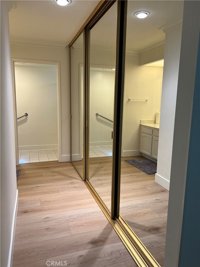 4018 Calle Sonora Este Unit C, Laguna Woods, CA 92637 - hall with crown molding, light wood-type flooring, and baseboards