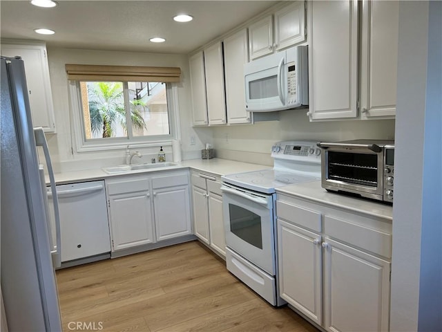 4018 Calle Sonora Este Unit C, Laguna Woods, CA 92637 - kitchen featuring white appliances, recessed lighting, white cabinetry, light wood-style flooring, and light countertops