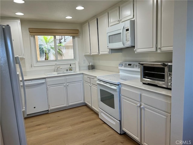 4018 Calle Sonora Este Unit C, Laguna Woods, CA 92637 - kitchen featuring white appliances, recessed lighting, white cabinetry, light wood-style floors, and light countertops