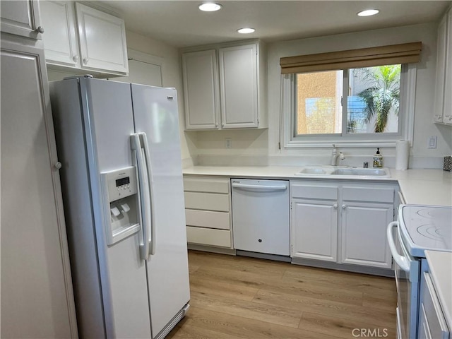 4018 Calle Sonora Este Unit C, Laguna Woods, CA 92637 - kitchen featuring white appliances, light countertops, recessed lighting, light wood finished floors, and white cabinetry