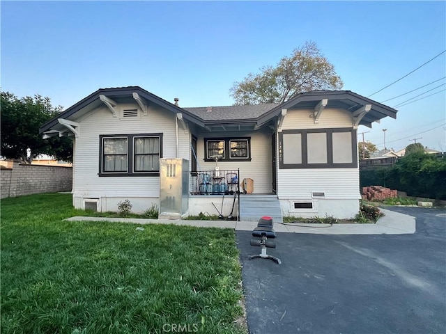 view of front of home with a front lawn and fence